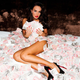 Illustration for article titled Tamara Ecclestone gets naked and rolls around in money